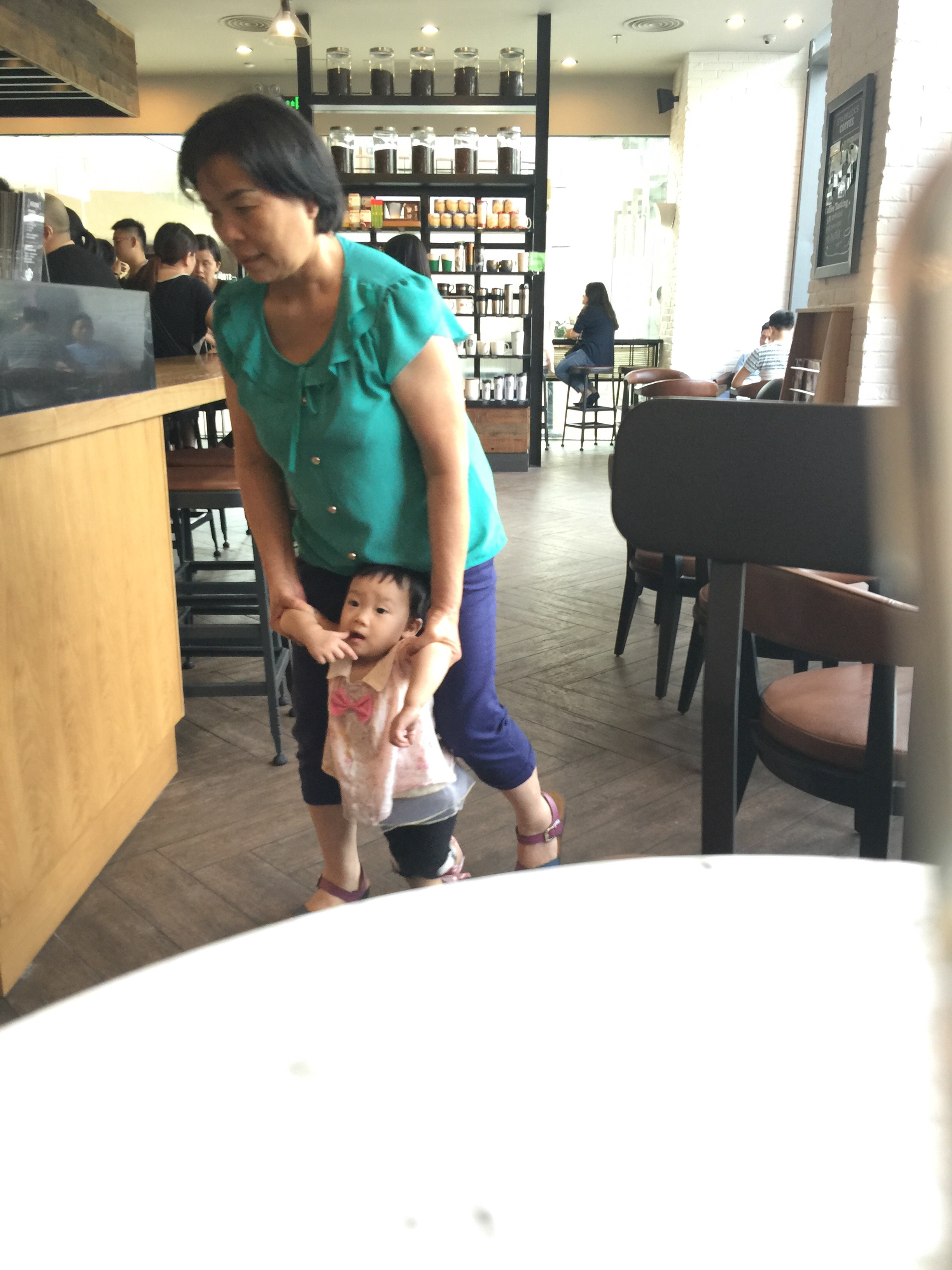 A customer with a small child at Suning Starbucks. Photo: Wency Lin