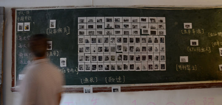 A man walks by an exhibition entitled “100 Strangers.” Photo by: Daisy